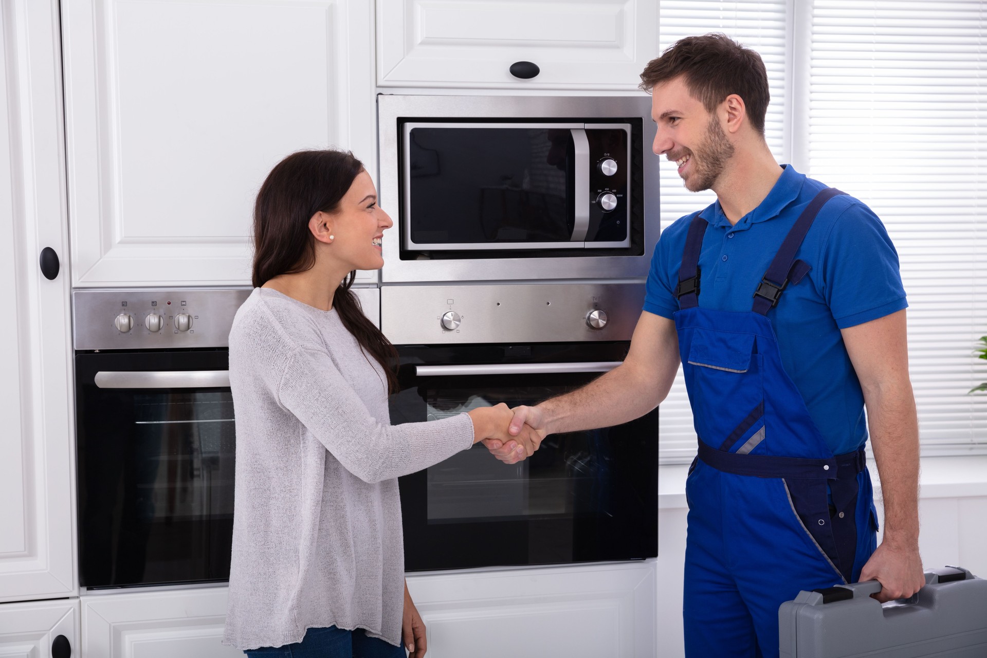 Serviceman Shaking Hands With Woman